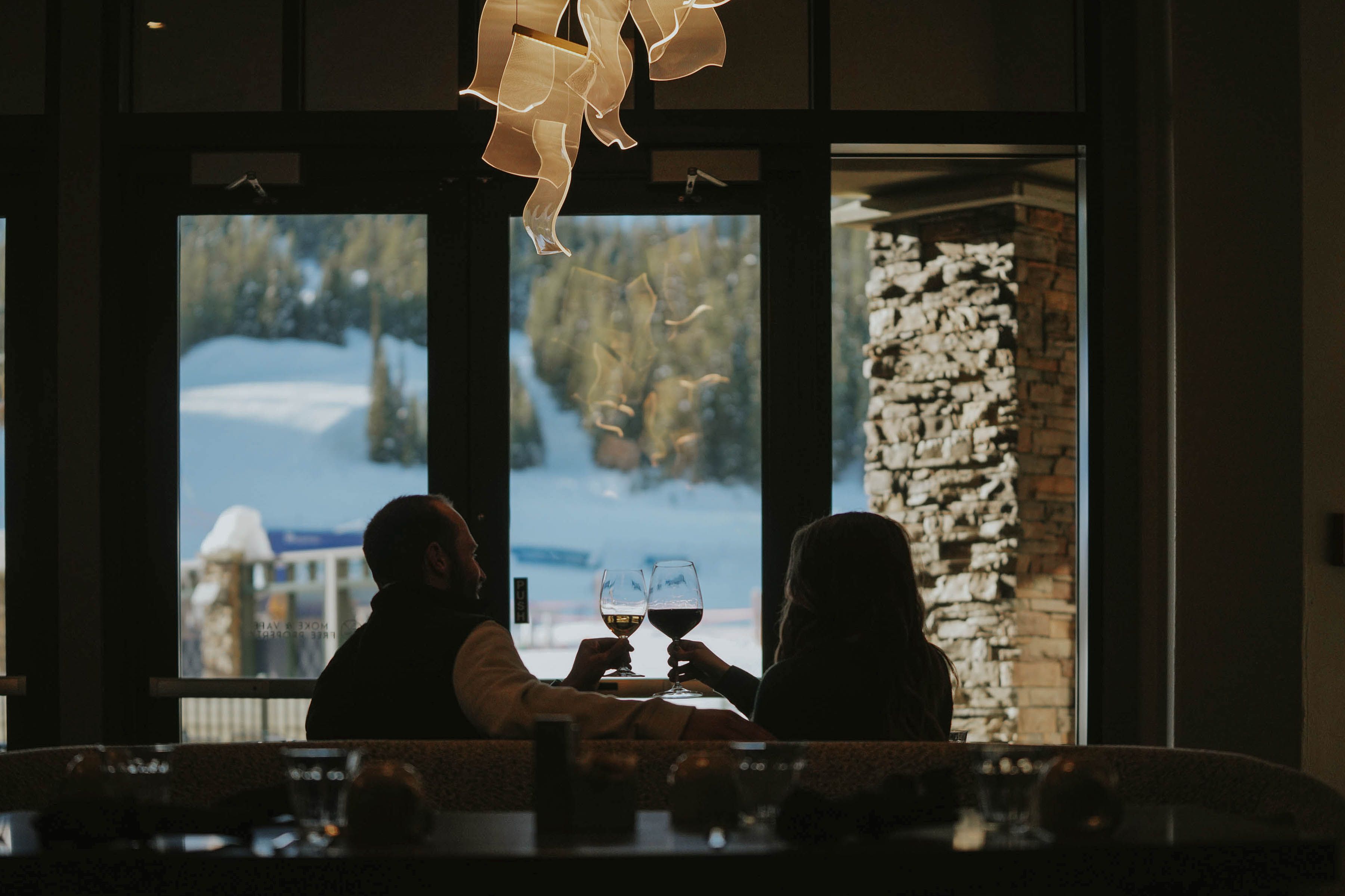 Couple cheersing drinks at Peaks Chophouse & Wine Lounge