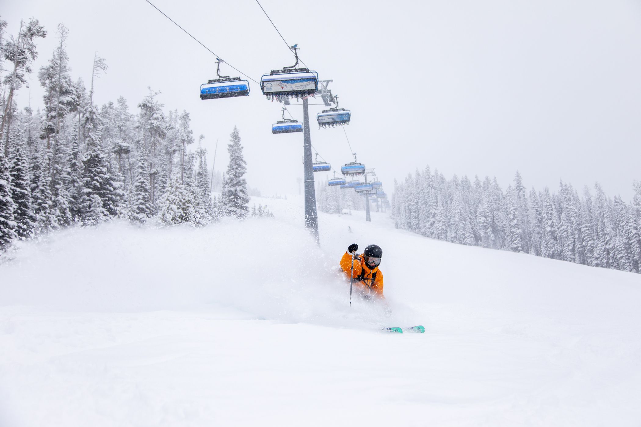 Powder skiing in front of a chairlift