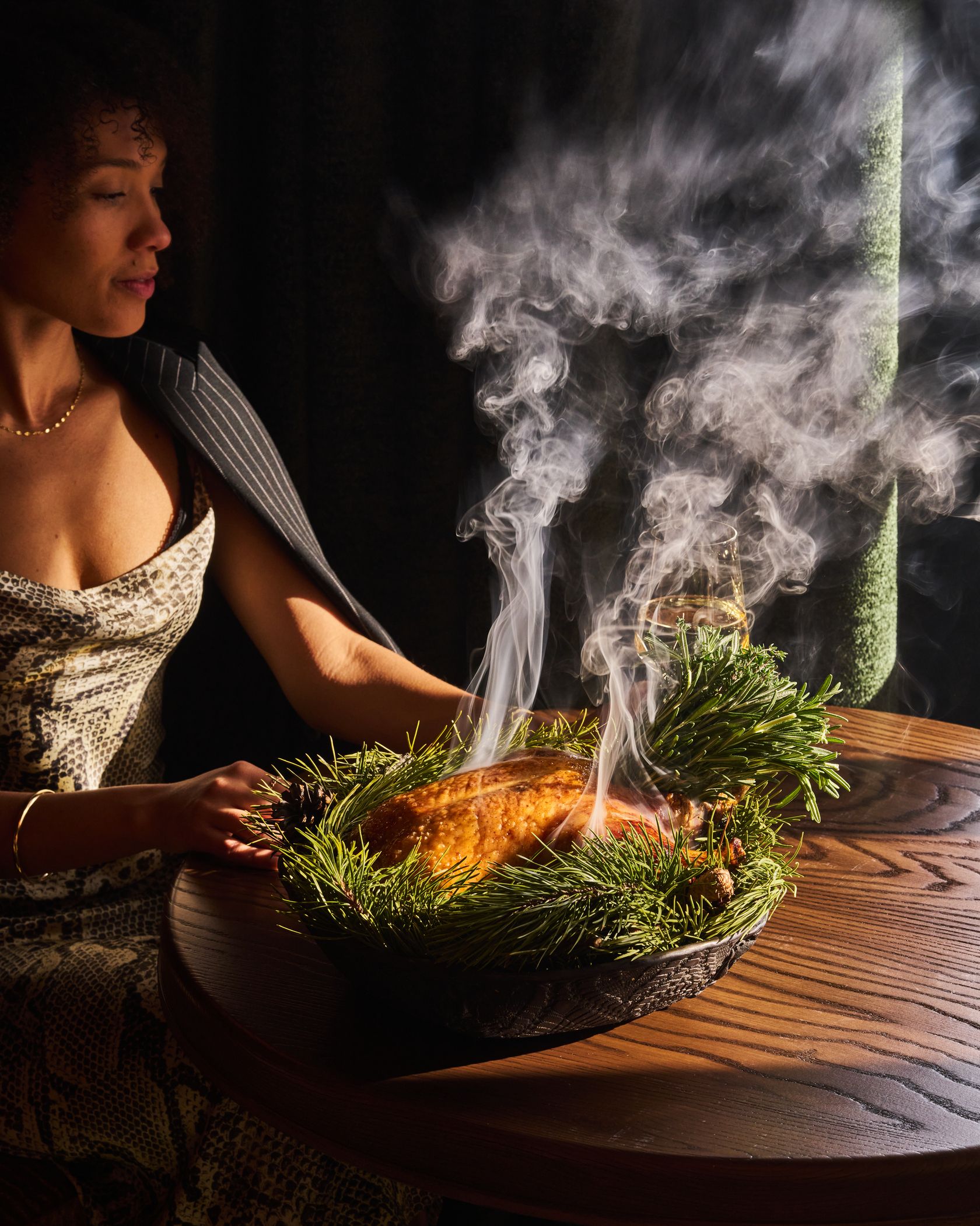 Woman sitting next to a steaming dish