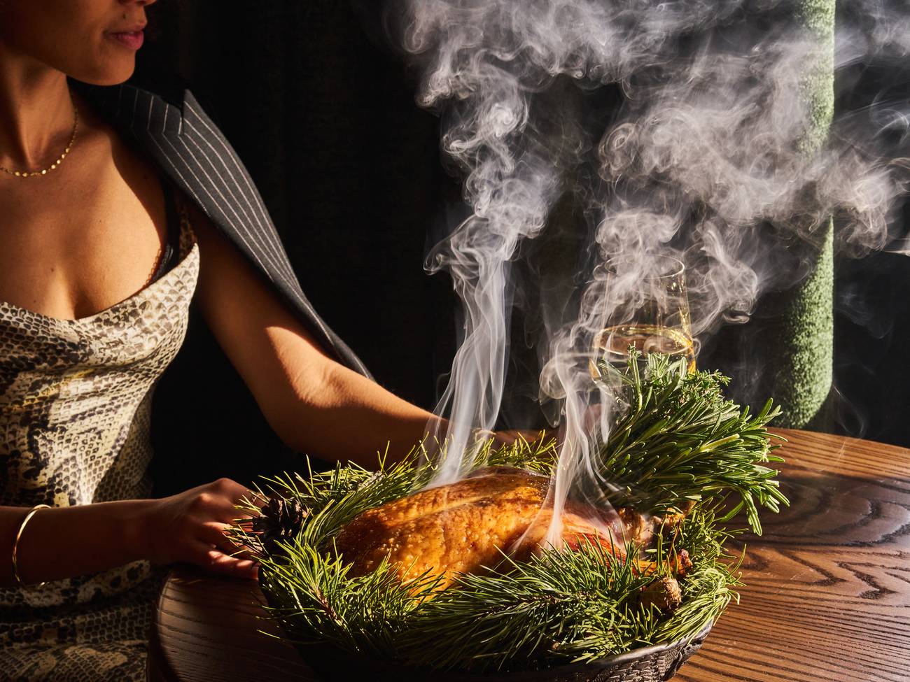 Woman sitting next to a steaming dish