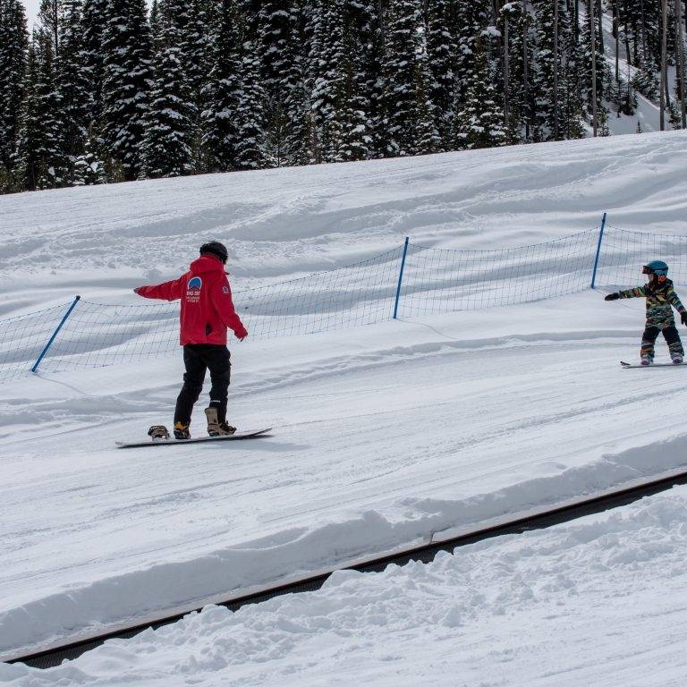 Child in a snowboarding lesson