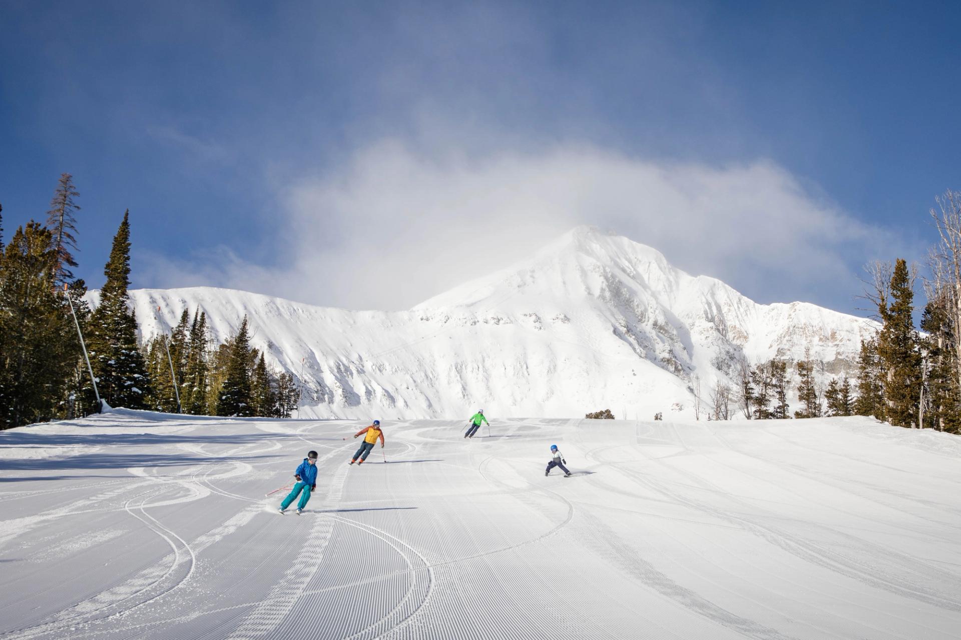 A family of four skis down the run Mr K