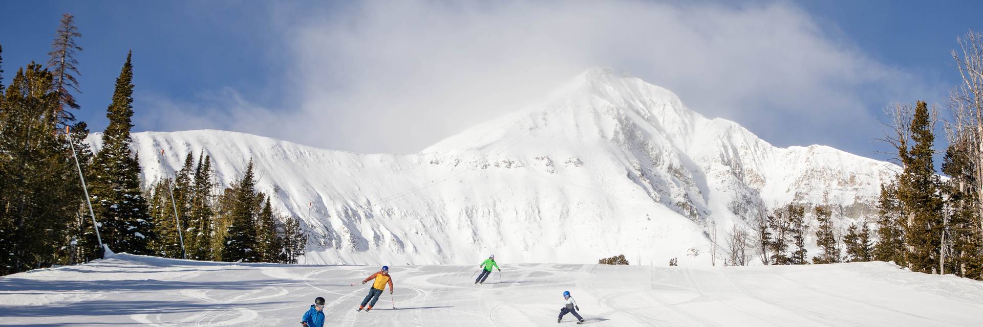 Family skiing on a groomed run
