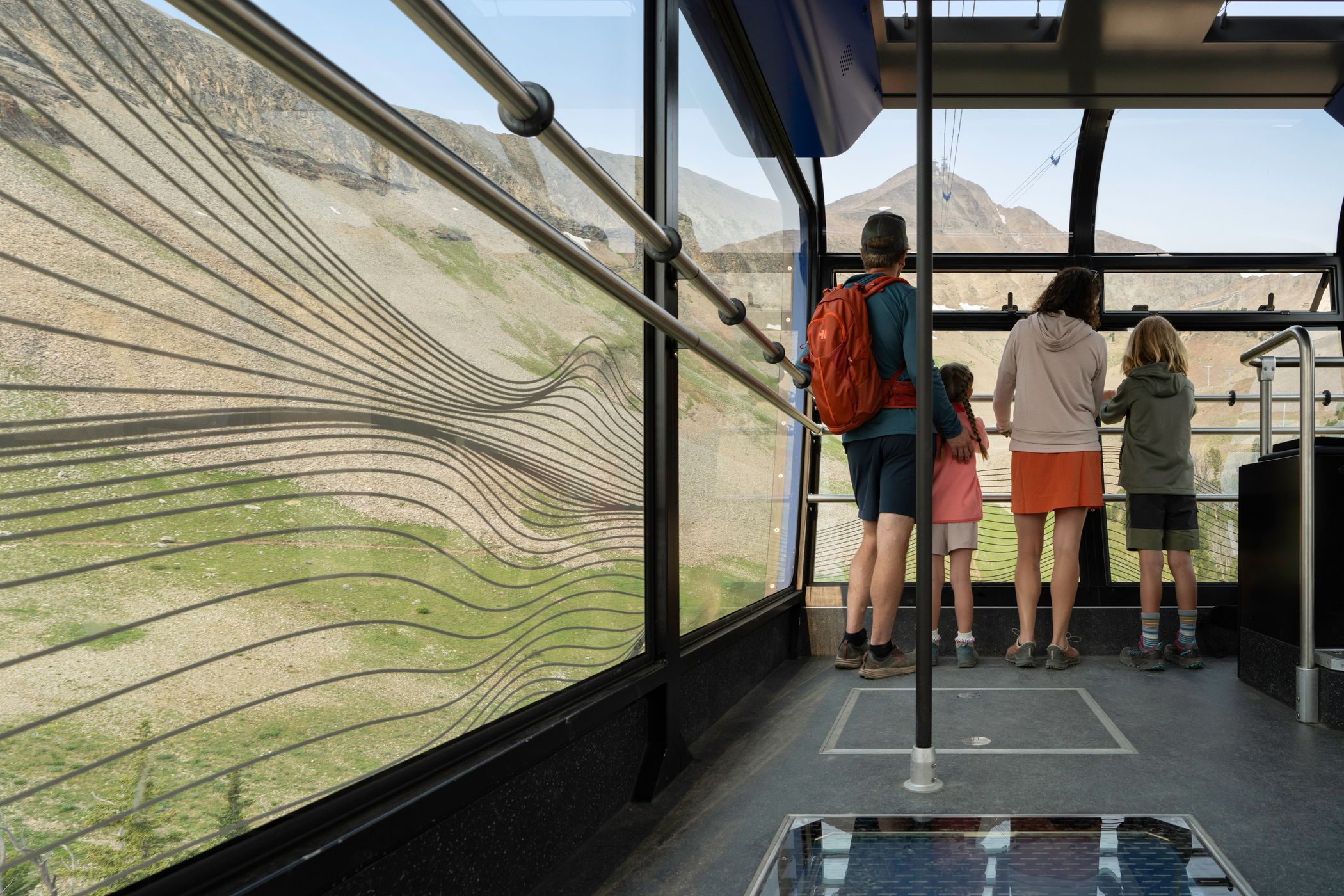Riders on the Lone Peak Tram in summer