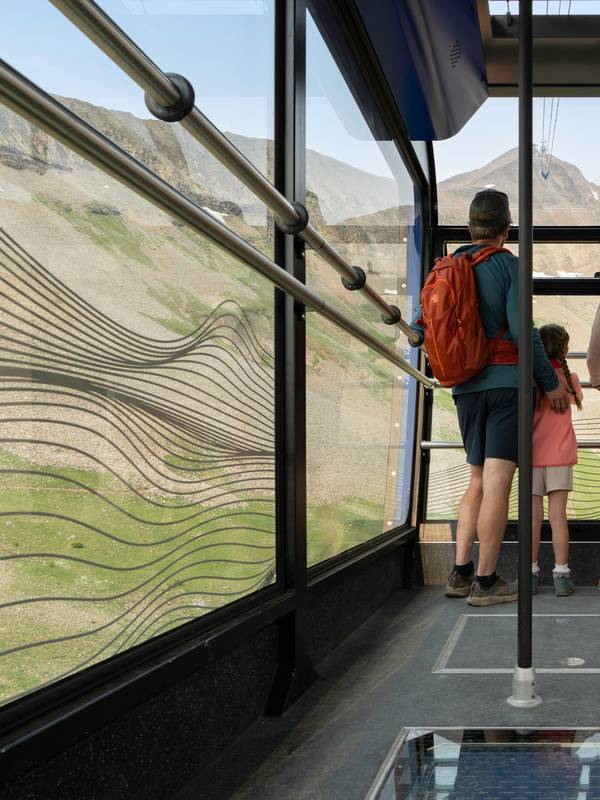 Riders on the Lone Peak Tram in summer