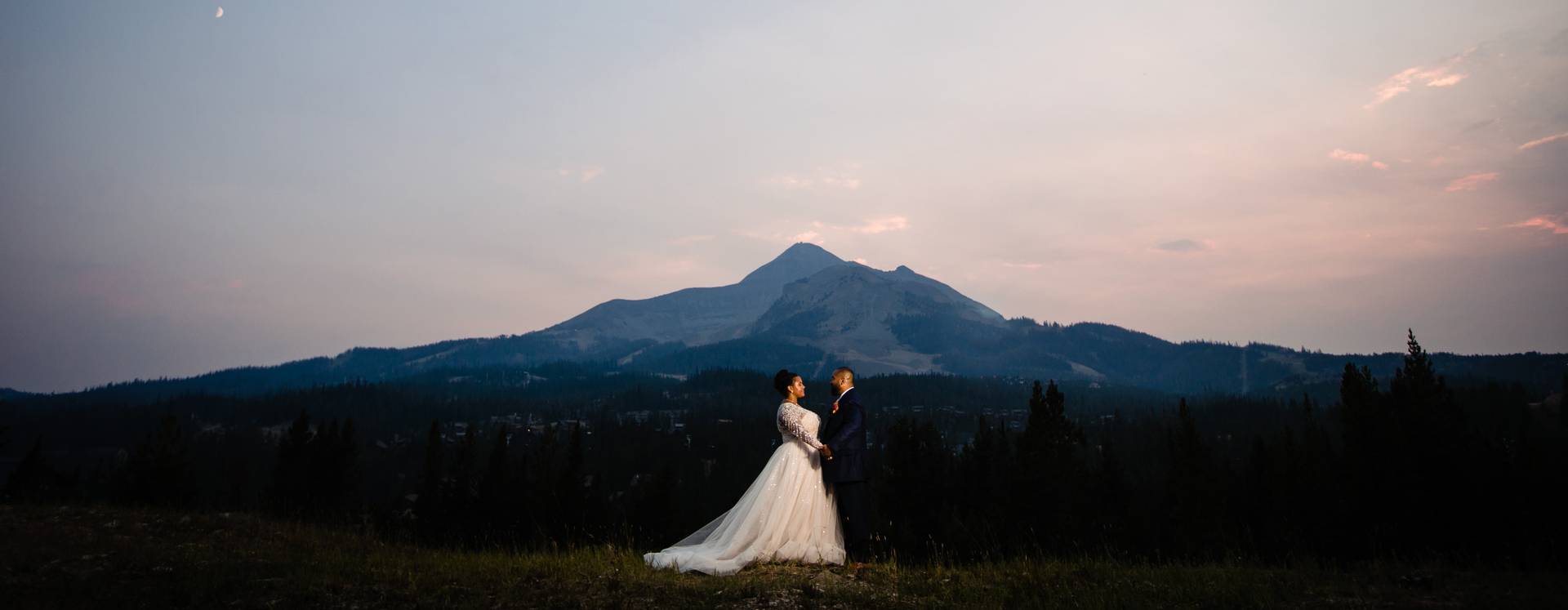 Couple in wedding clothes in front of Lone Peak