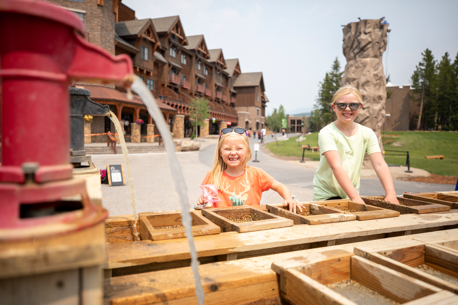 Two girls gemstone mining in the Mountain Village plaza