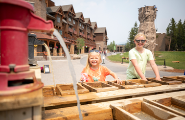 Two girls gemstone mining in the Mountain Village plaza