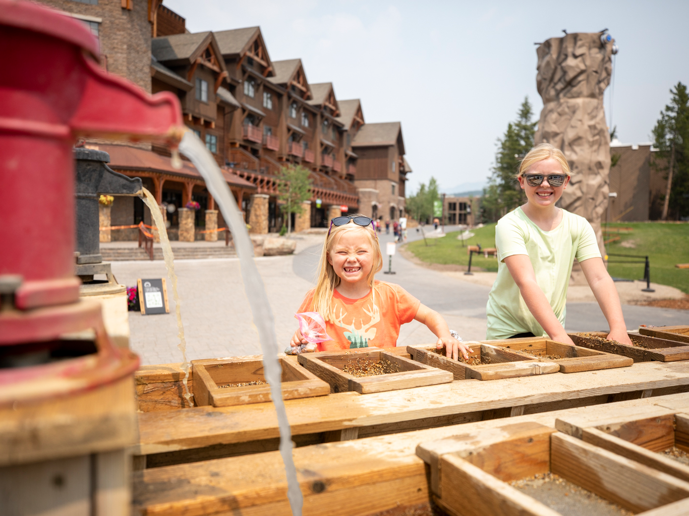Two kids at a gemstone mining station