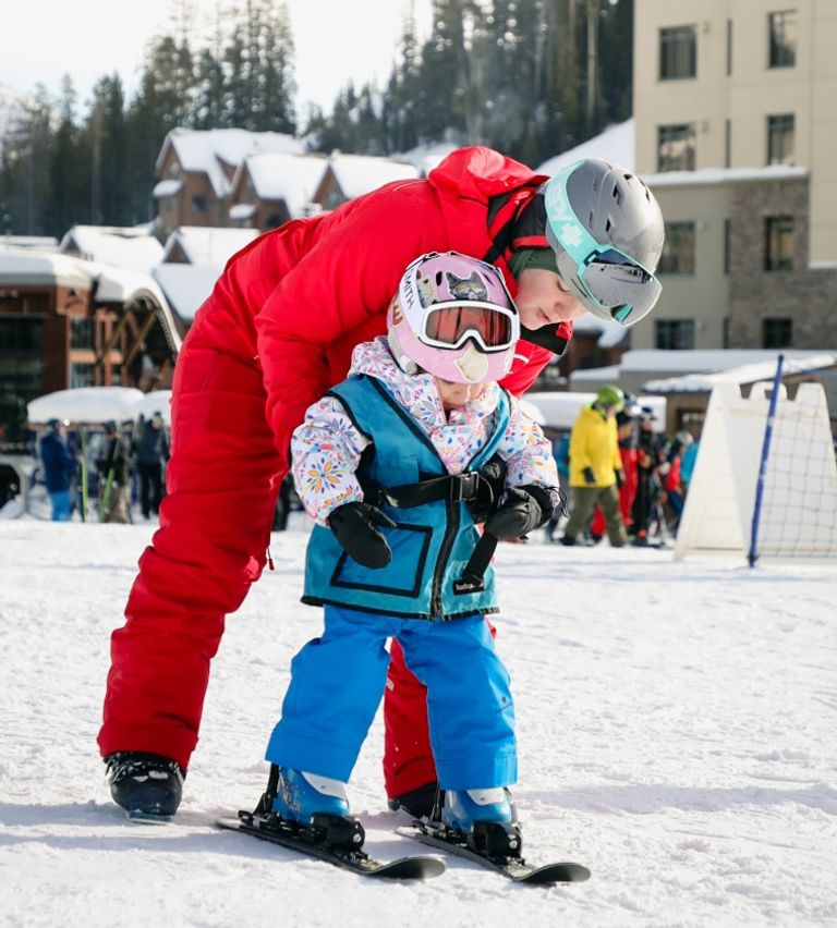 Instructor with a young skier