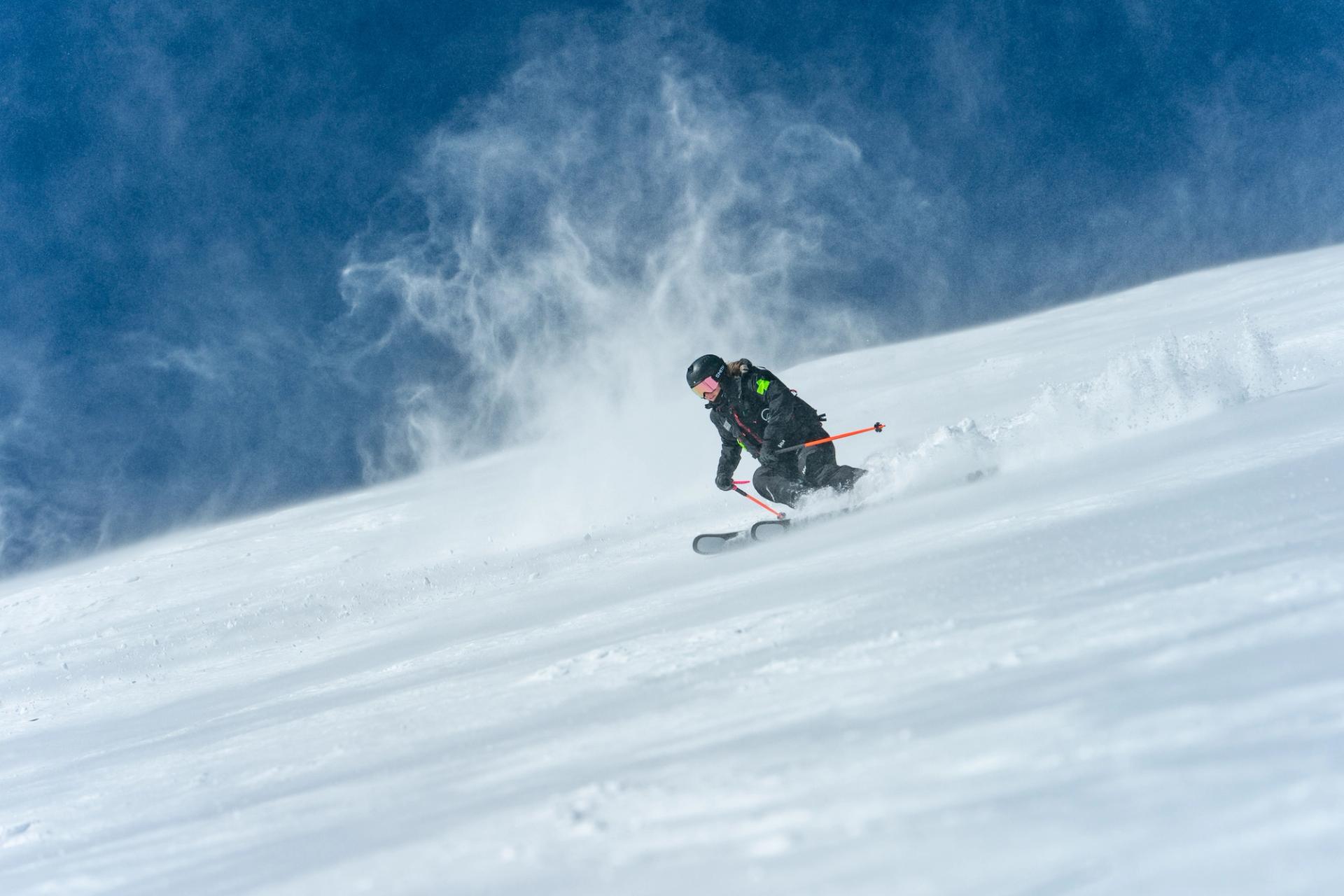 Nancy skiing off the peak while working