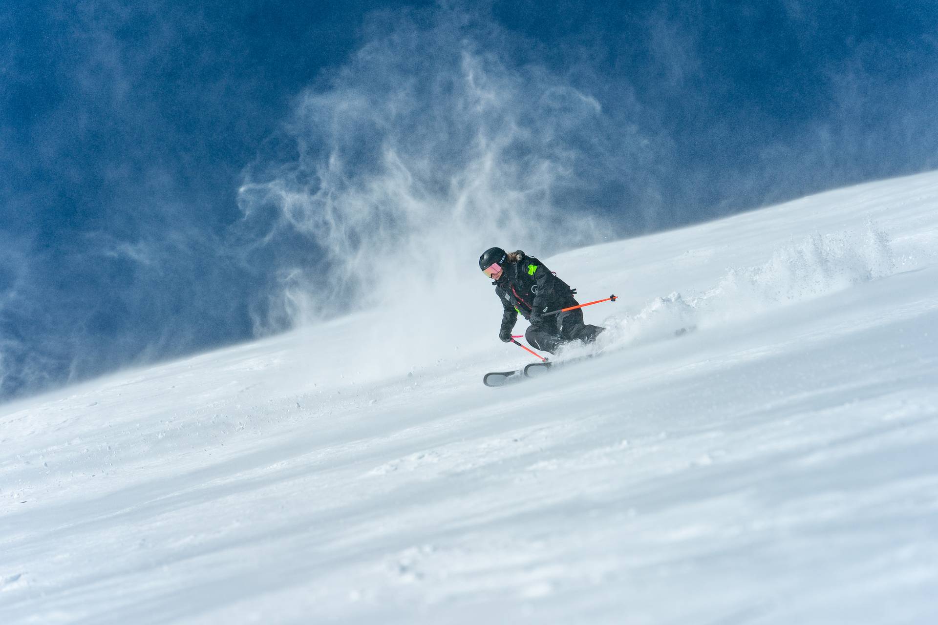 Nancy skiing off the peak while working