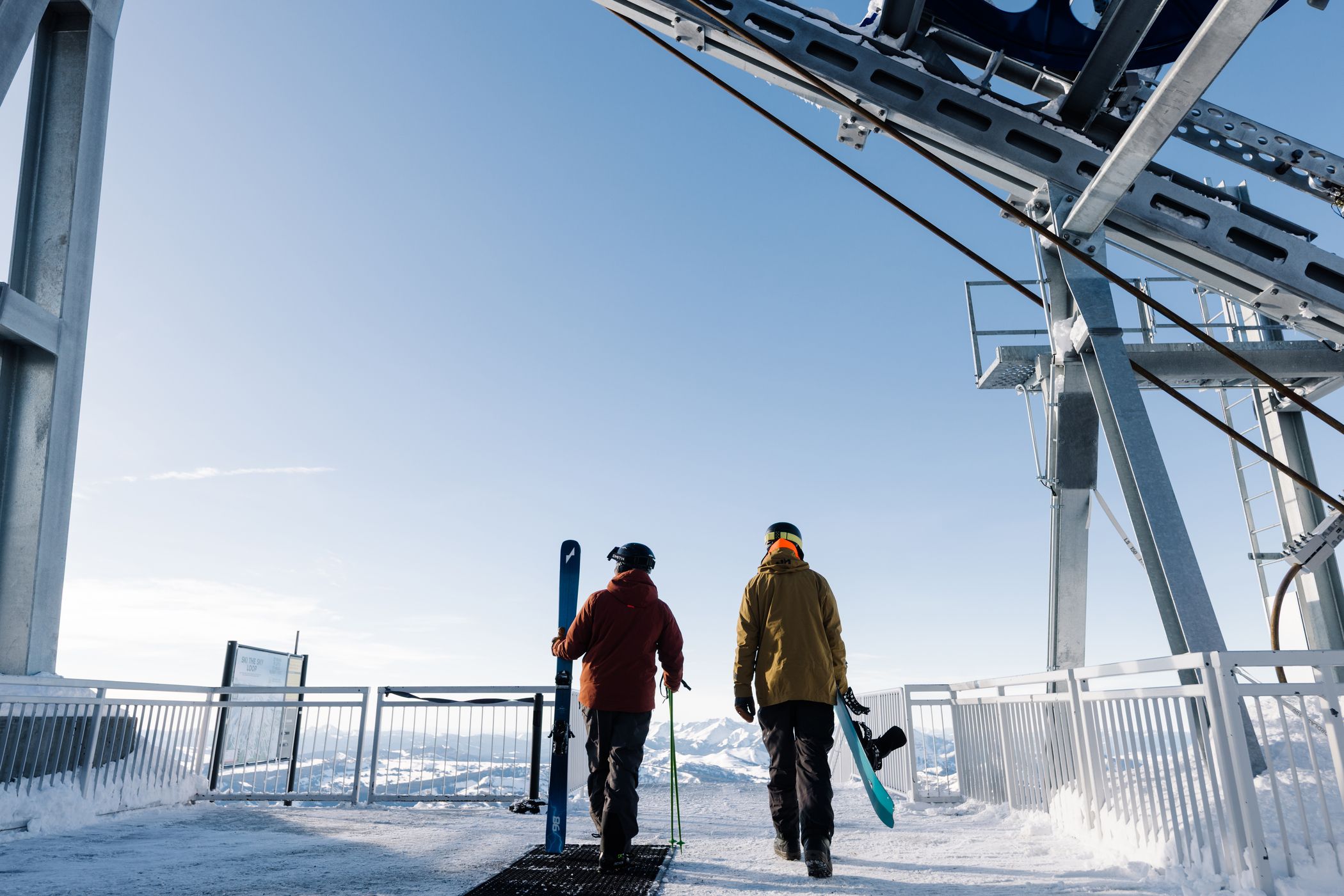 Skier and snowboarder at the top of t Lone Peak Tram