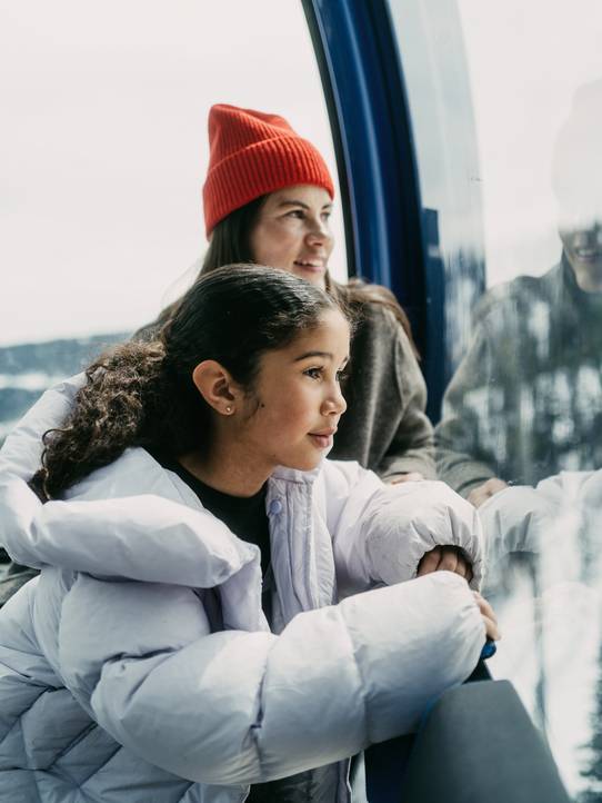 Girl in ski gear looking out at Kircliff