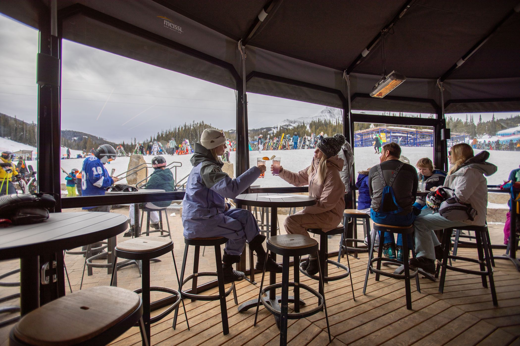 People in ski gear with drinks in the Umbrella Bar