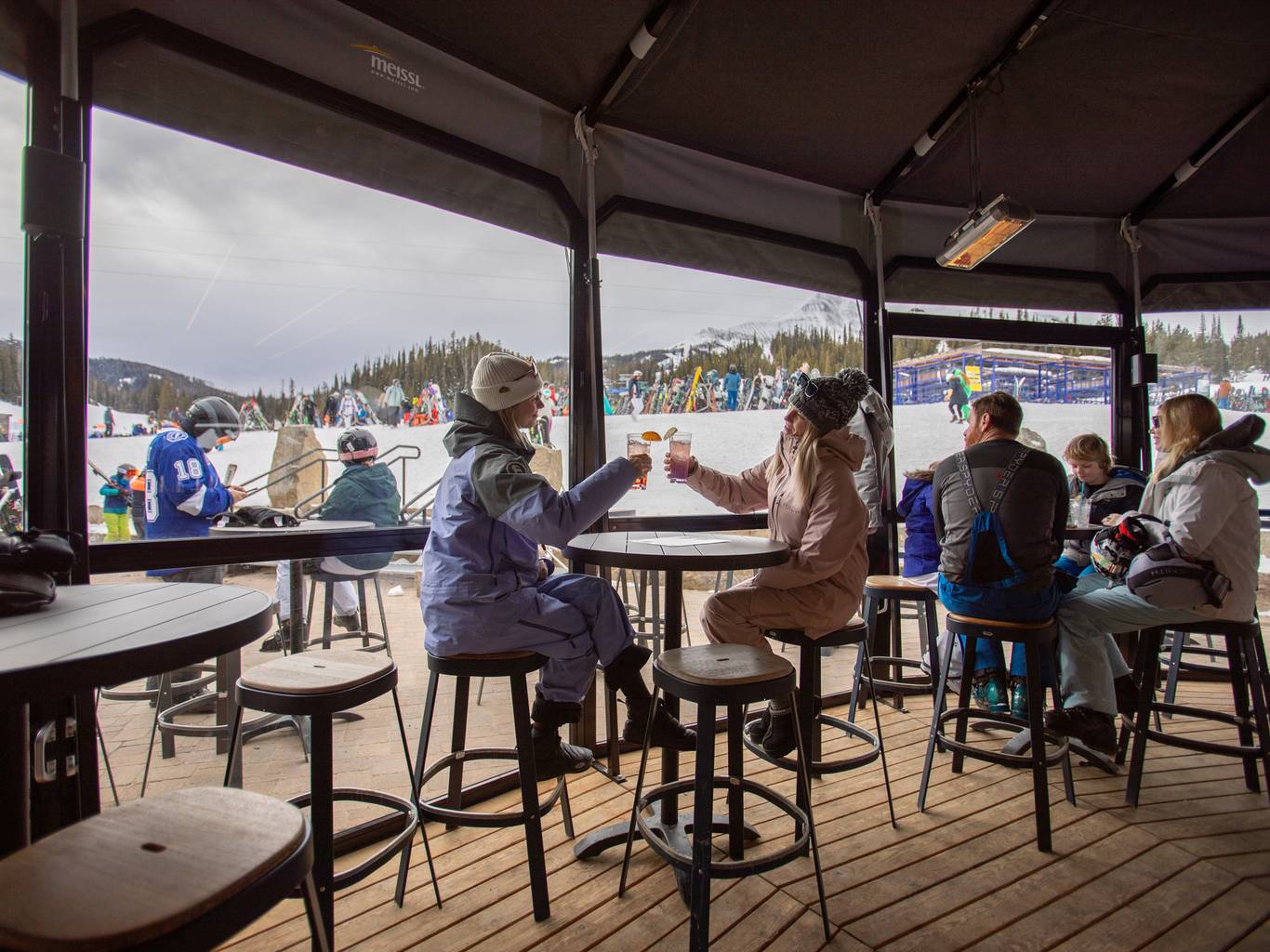 People in ski gear with drinks in the Umbrella Bar