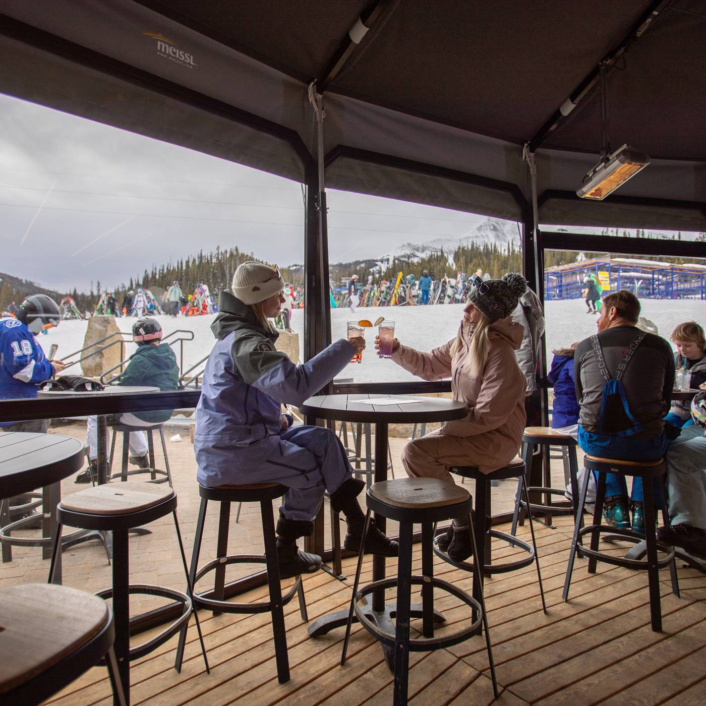 People in ski gear with drinks in the Umbrella Bar
