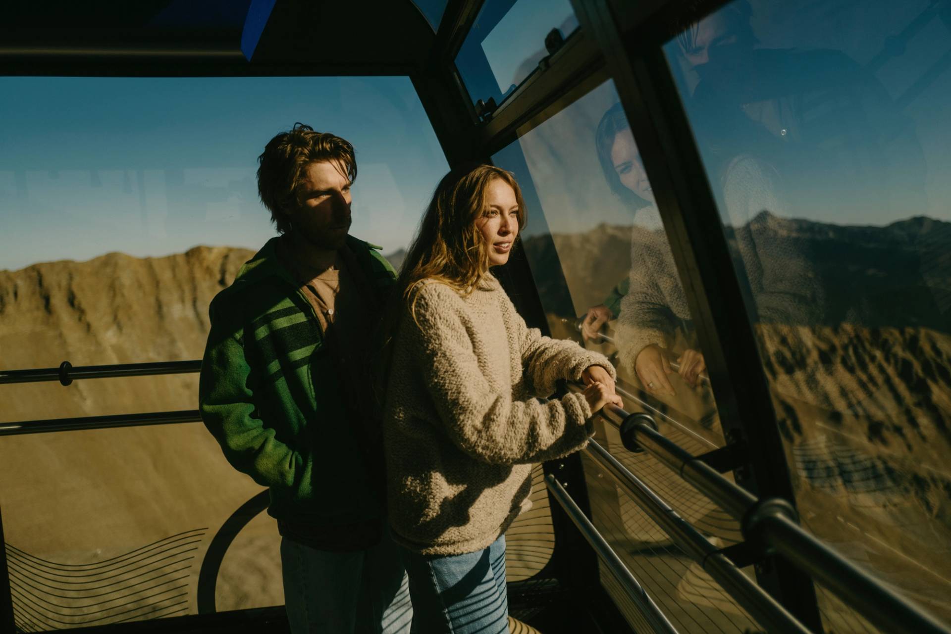 Two people looking out from the Lone Peak Tram