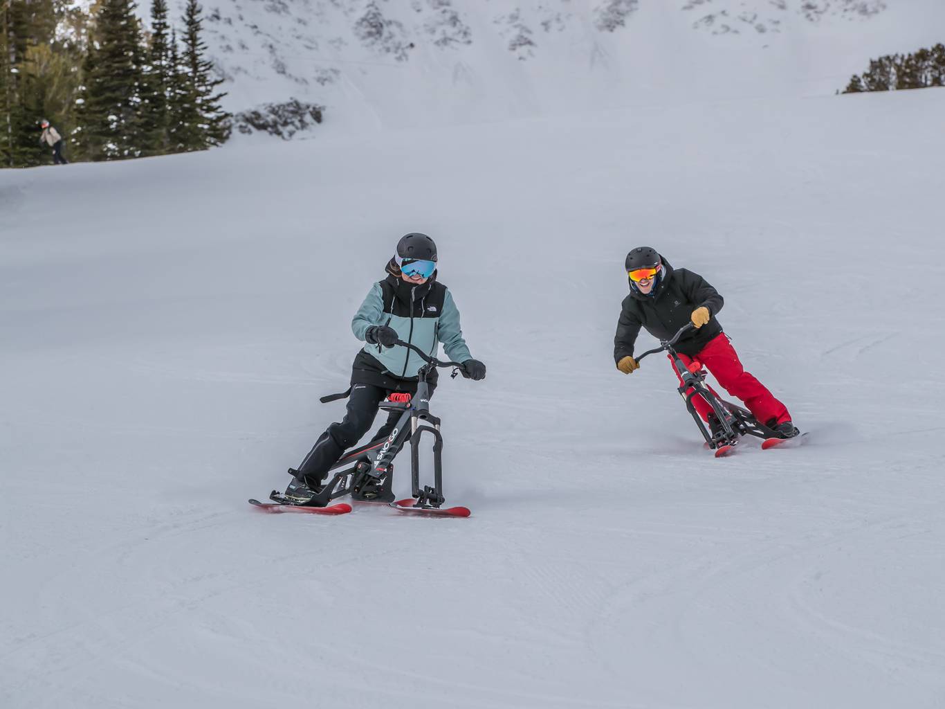 People riding Sno-Go bikes