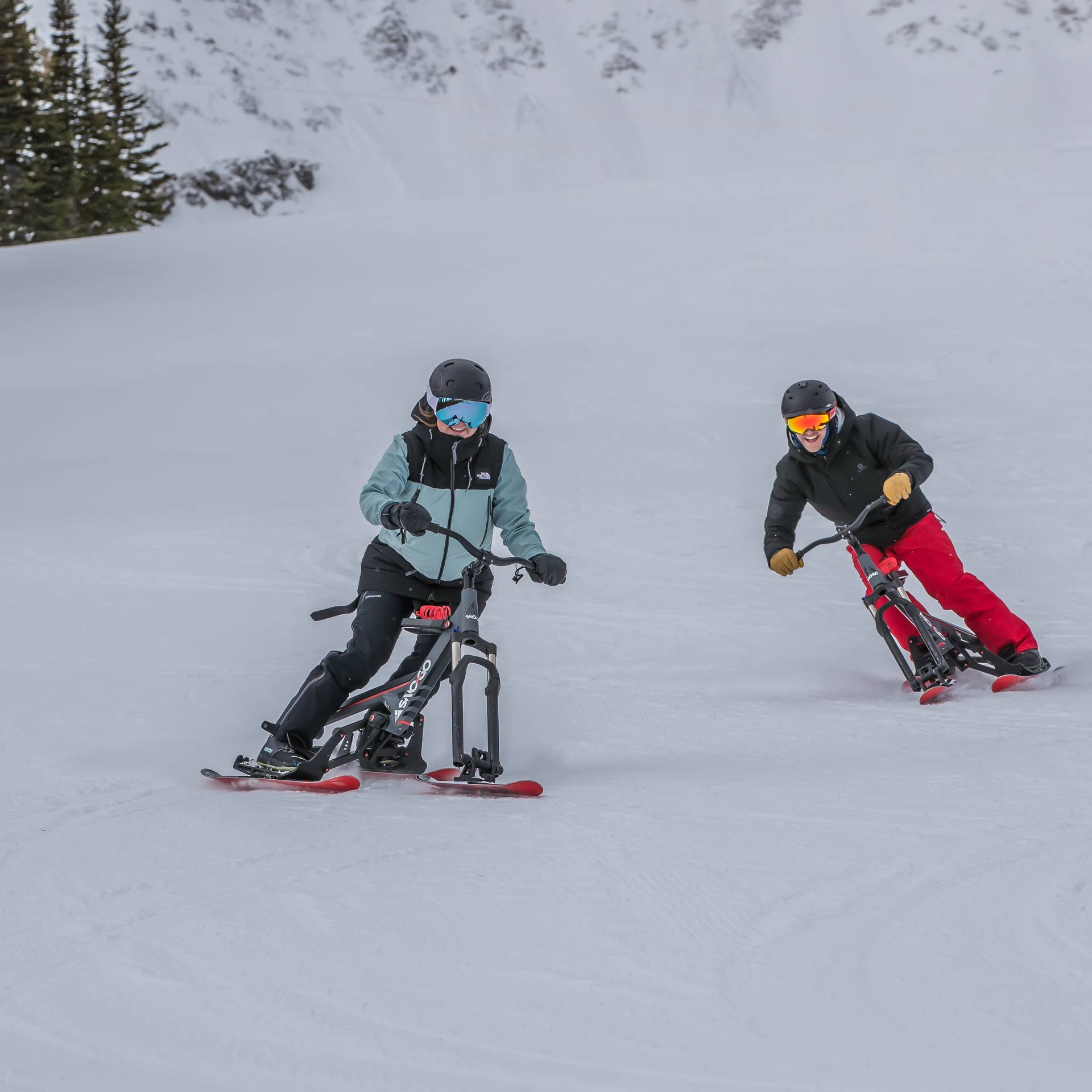 People riding Sno-Go bikes