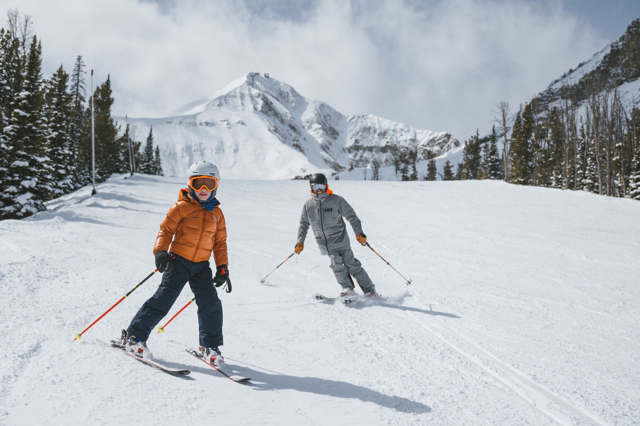Family skiing with Lone Peak in the background
