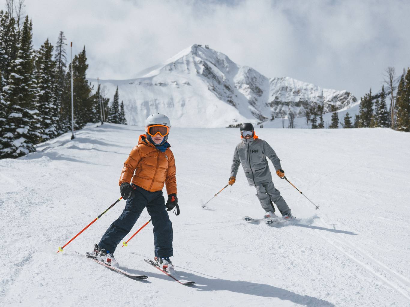 Family skiing with Lone Peak in the background