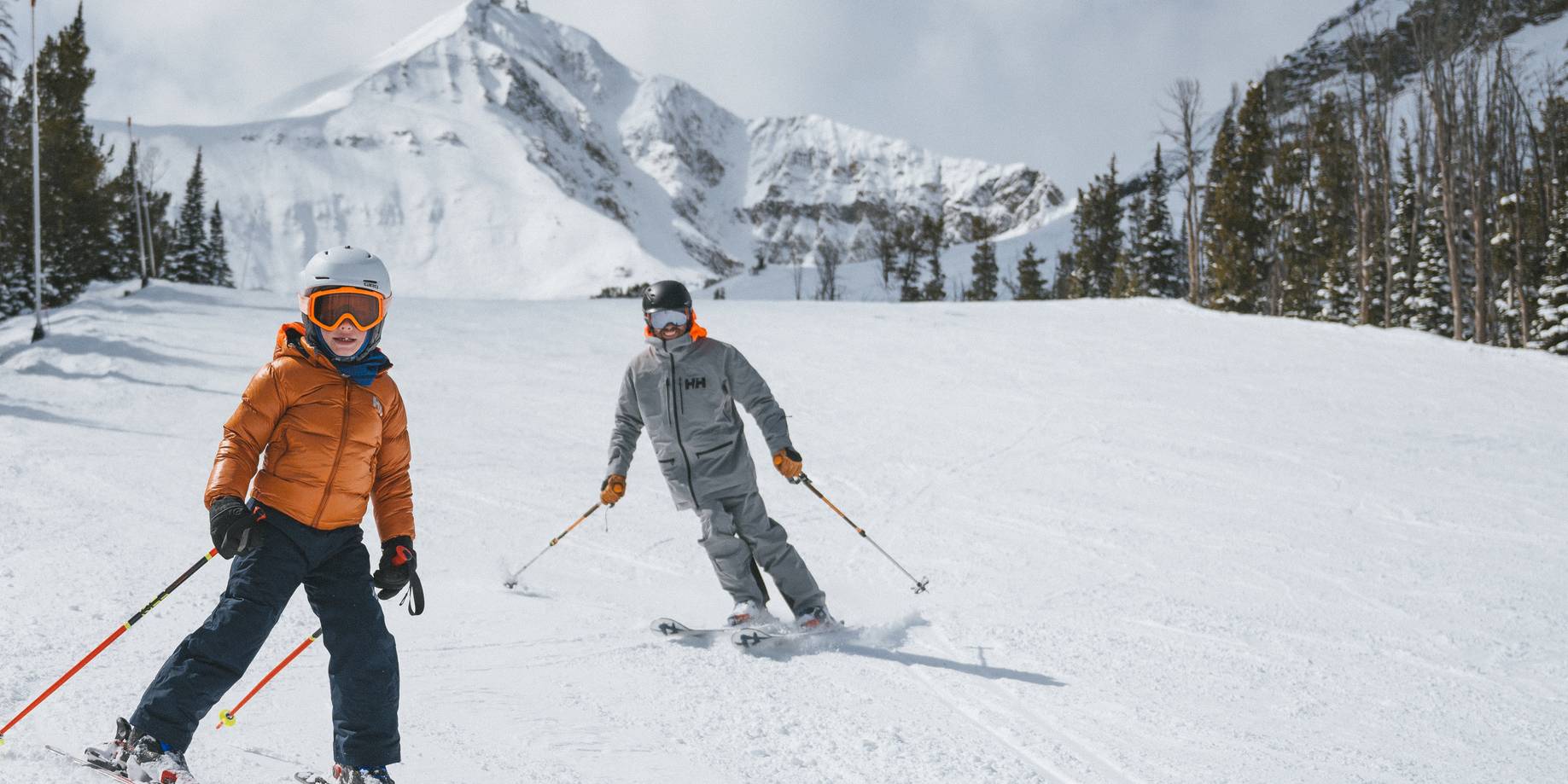 Family skiing with Lone Peak in the background