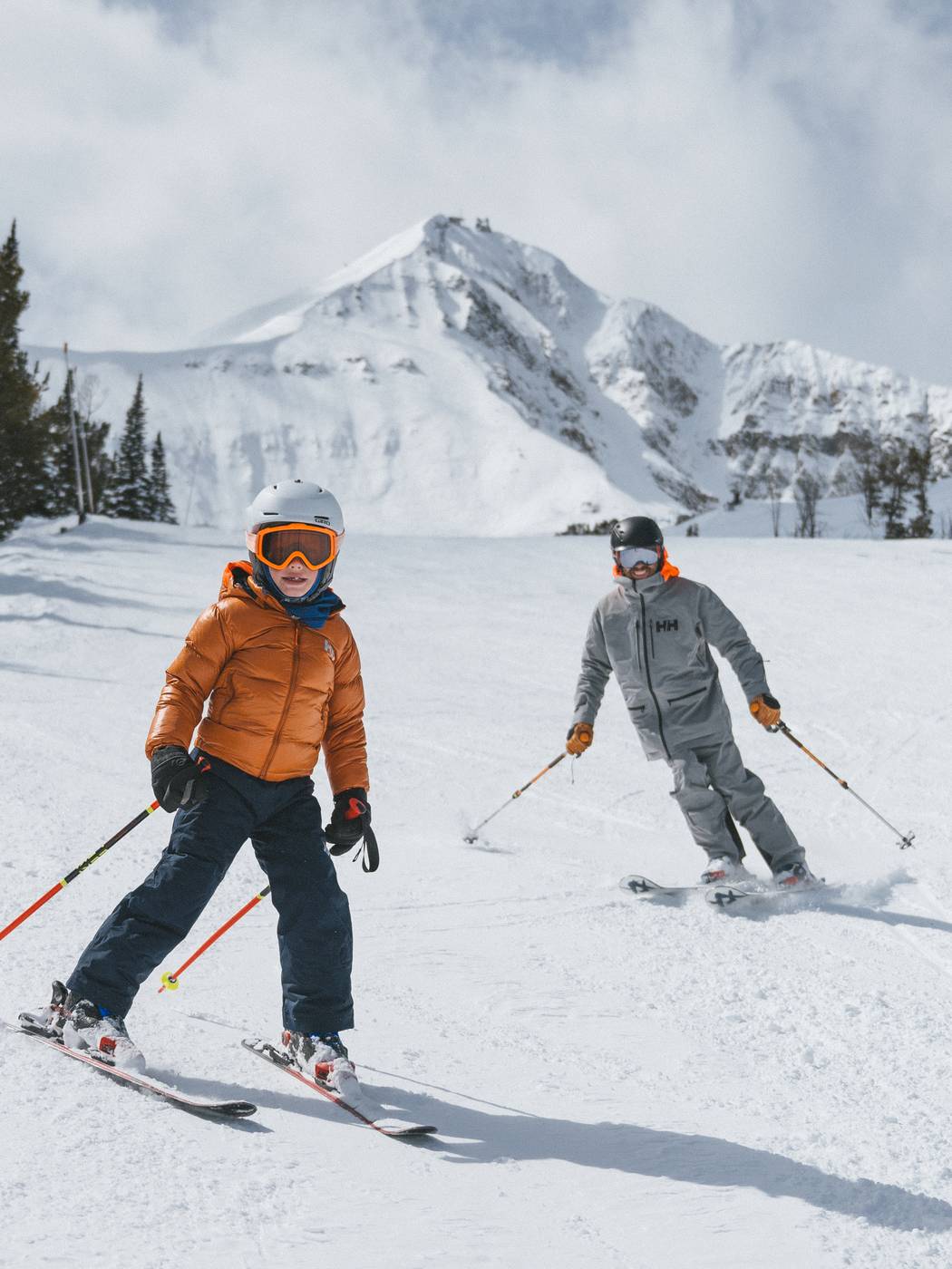Family skiing with Lone Peak in the background