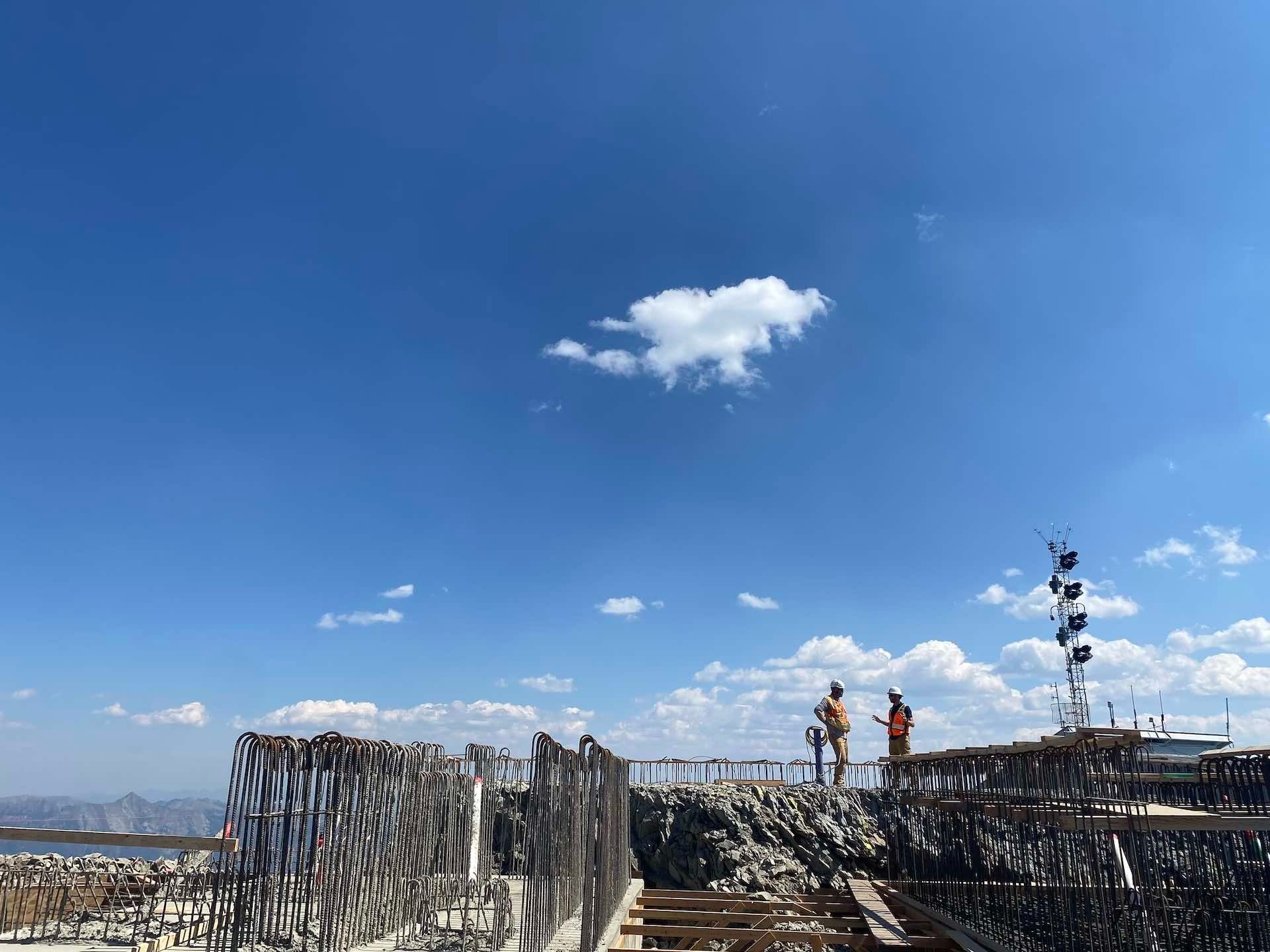 Chad talks with a construction worker at the top of Lone Peak