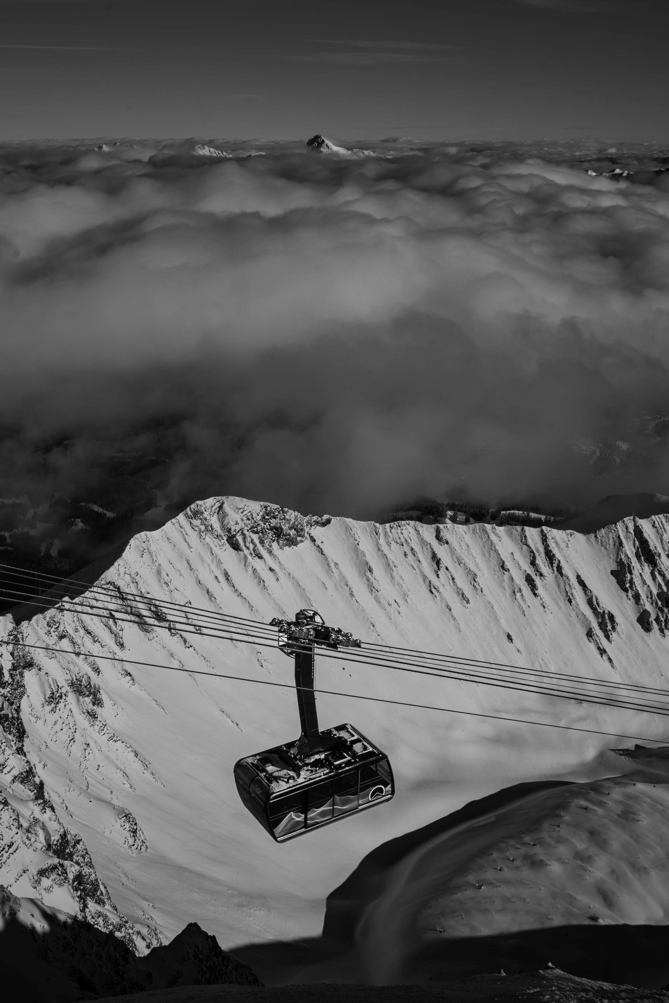 Black and white photo of the Lone Peak Tram and A-Z ridge in winter