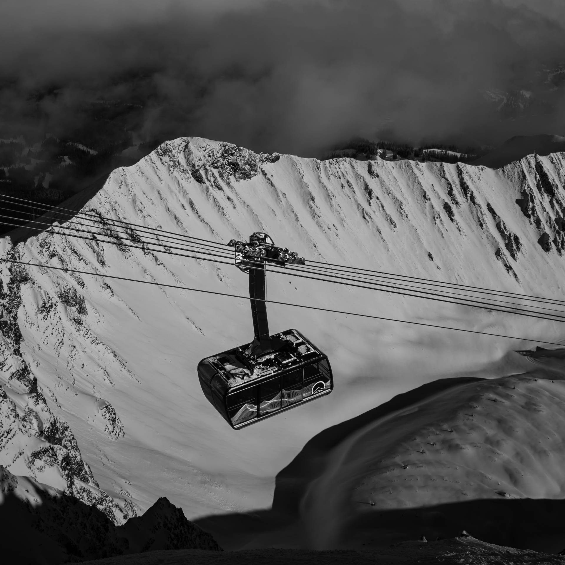 Black and white photo of the Lone Peak Tram and A-Z ridge in winter