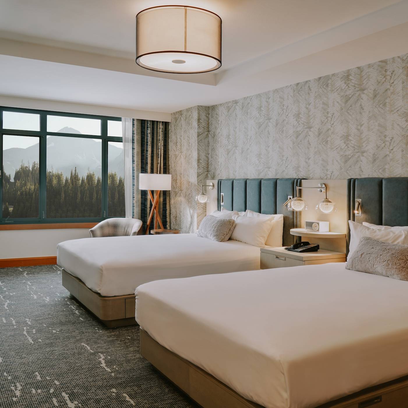 Hotel room with a view of a mountain out of the window