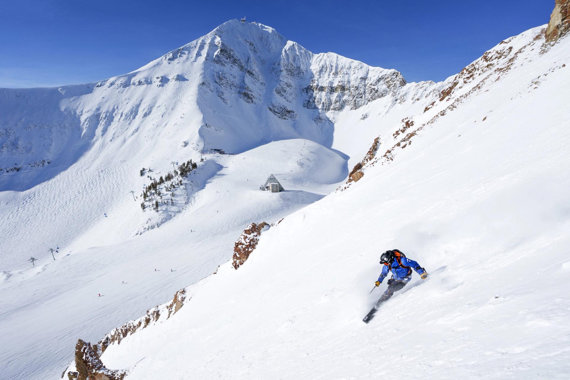 Skier in powder with Lone Peak in the background