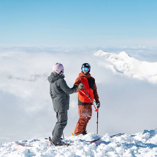Skiers at the top of Lone Mountain
