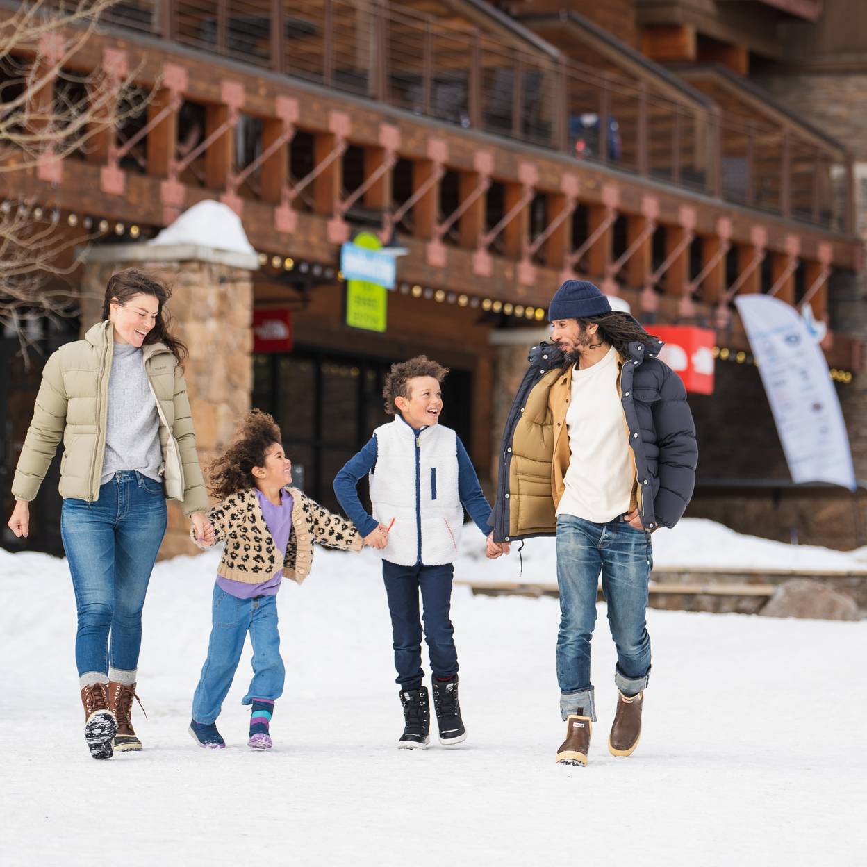 Family walking through Mountain Village in winter