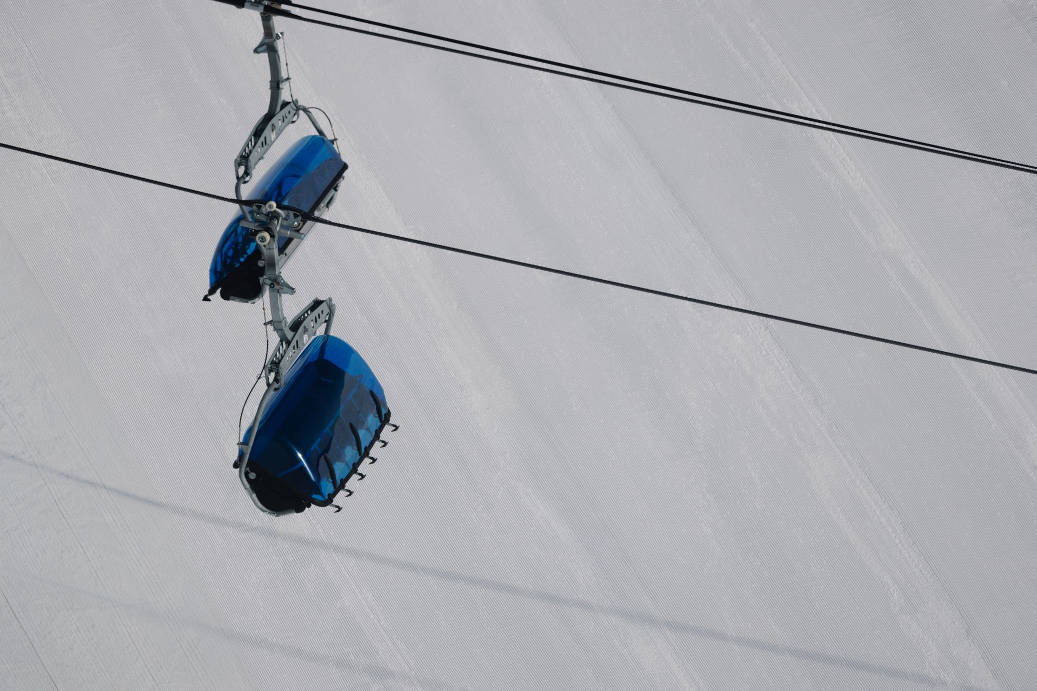 Bubble chairlift with groomed snow in the background