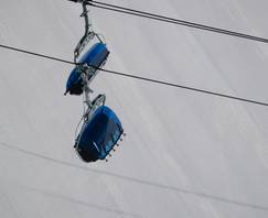 Bubble chairlifts with a groomed run in the background