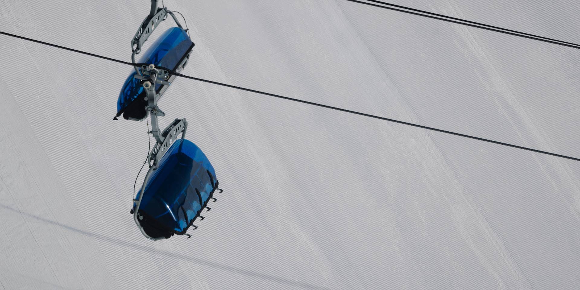 Bubble chairlift with groomed snow in the background