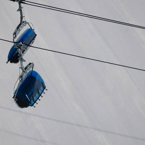 Bubble chairlift with groomed snow in the background