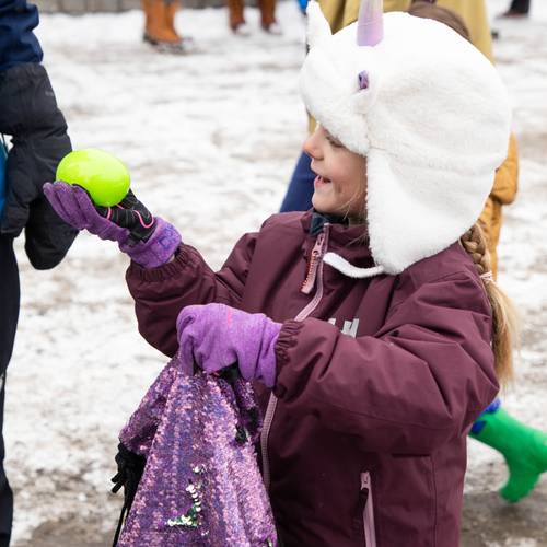 Girl in ski gear holding an easter egg