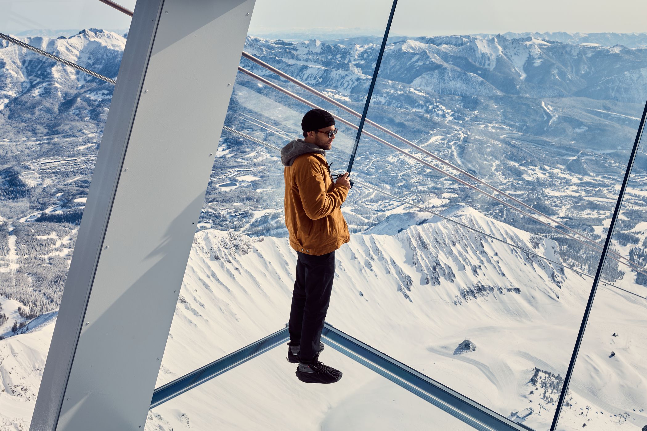 Man standing on the glass floor at Kircliff in winter