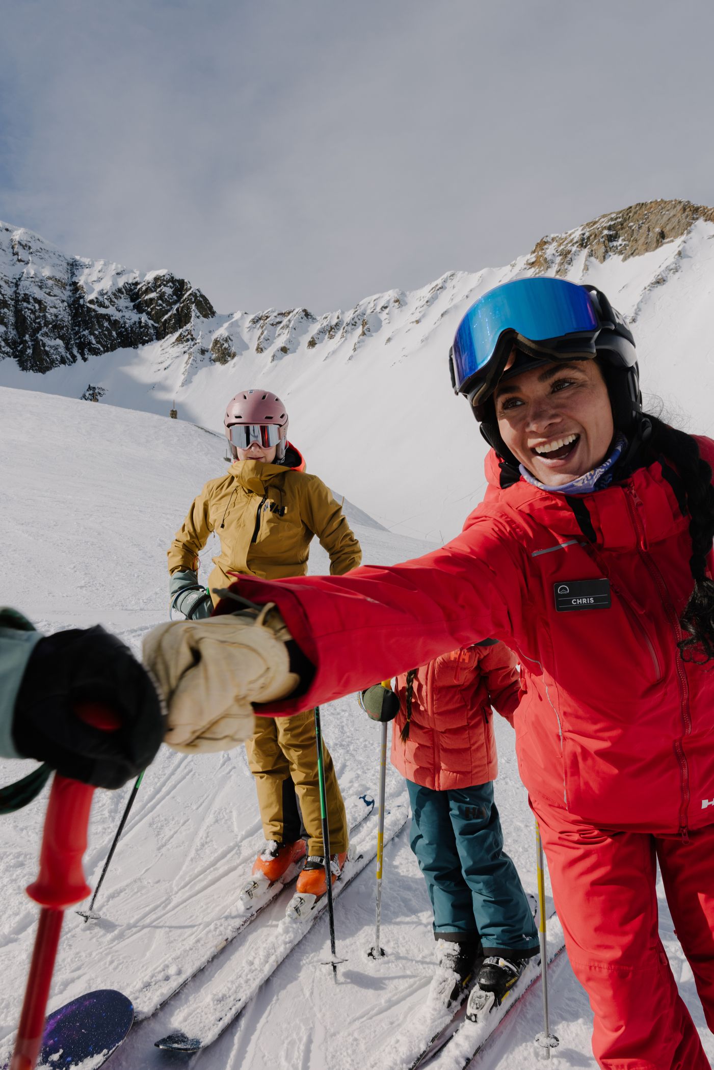 Ski instructor fist-pumping another person in ski gear