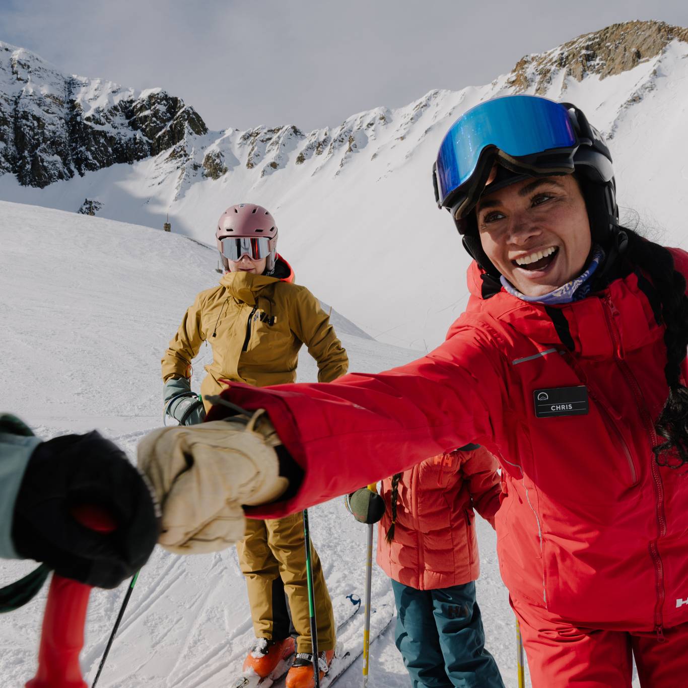 Ski instructor fist-pumping another person in ski gear