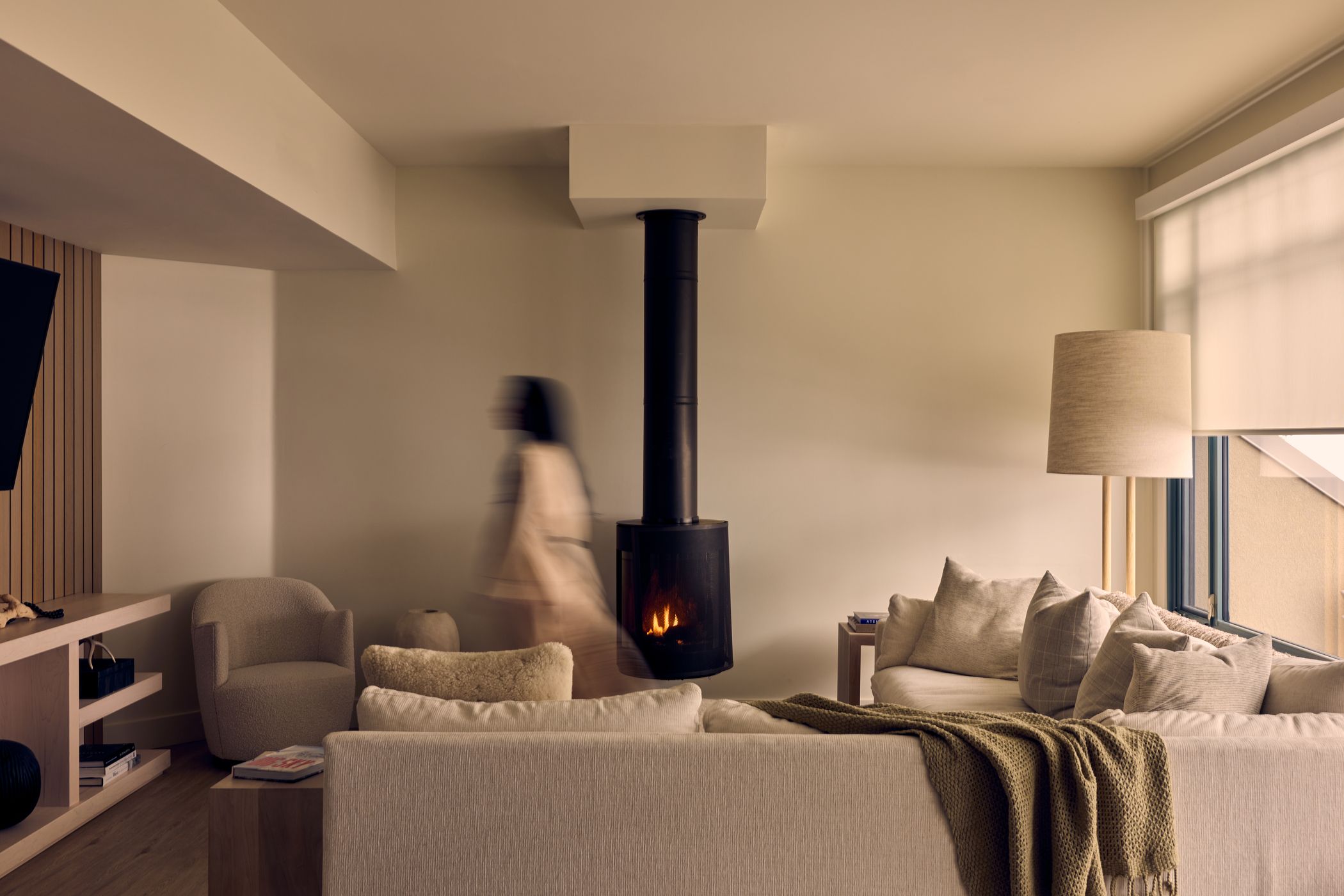 Woman walking through a hotel living room