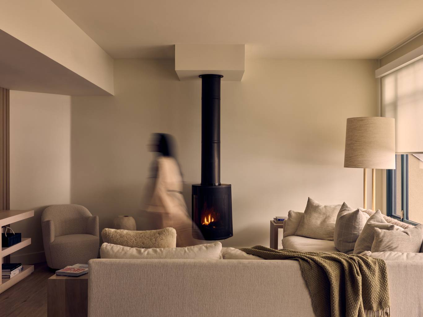 Woman walking through a hotel living room