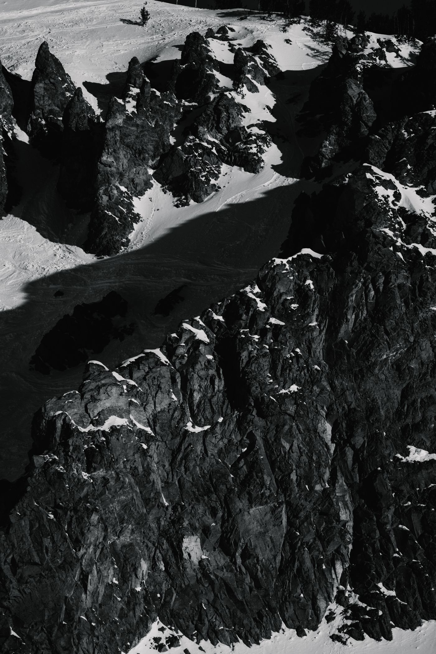 Black and white photo of cliffs covered in snow