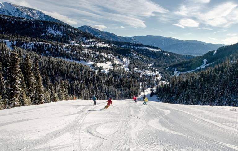 a group of skiers skis down Elk Park ridge