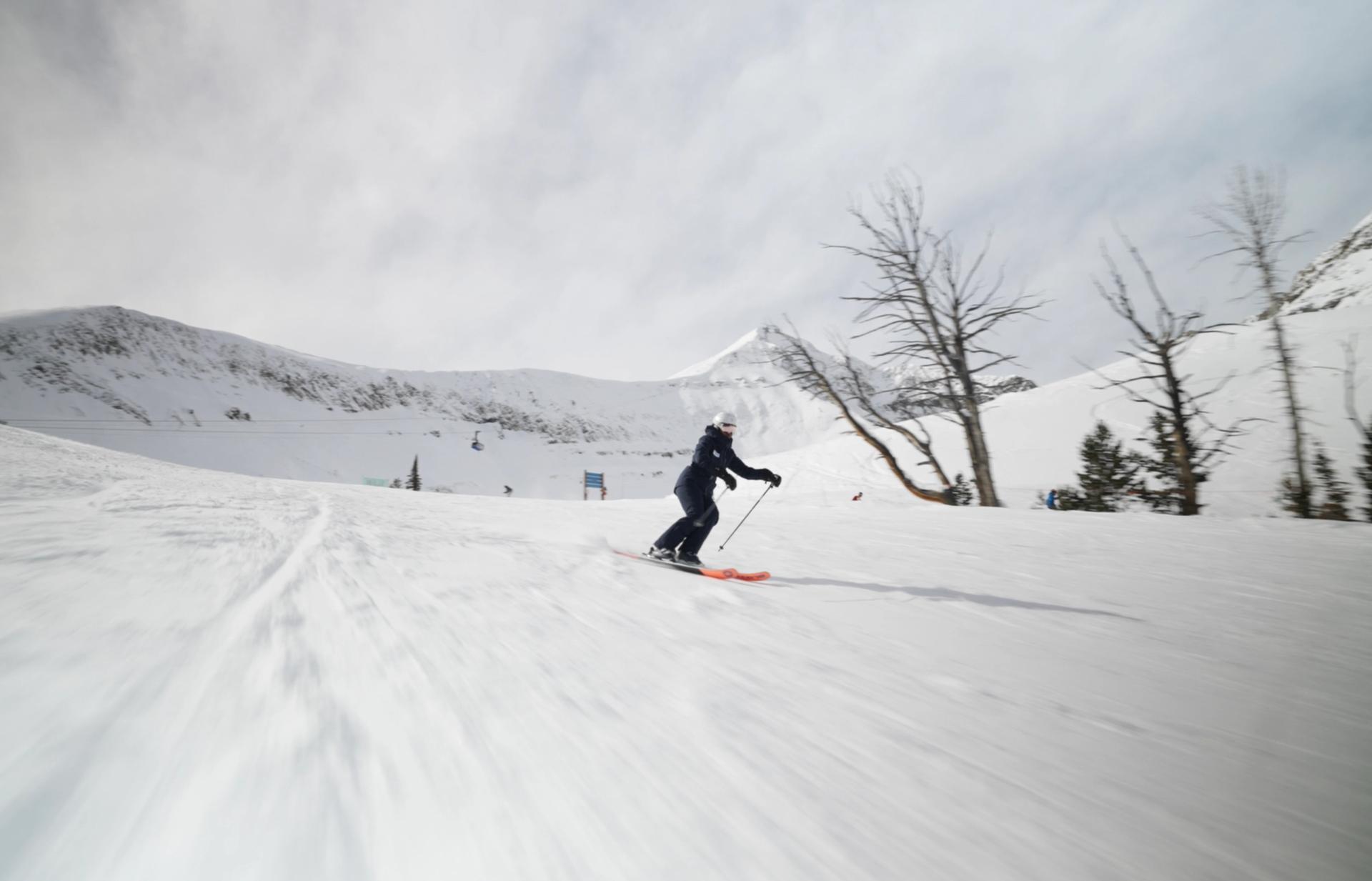 Carolyn skiing on a groomed run