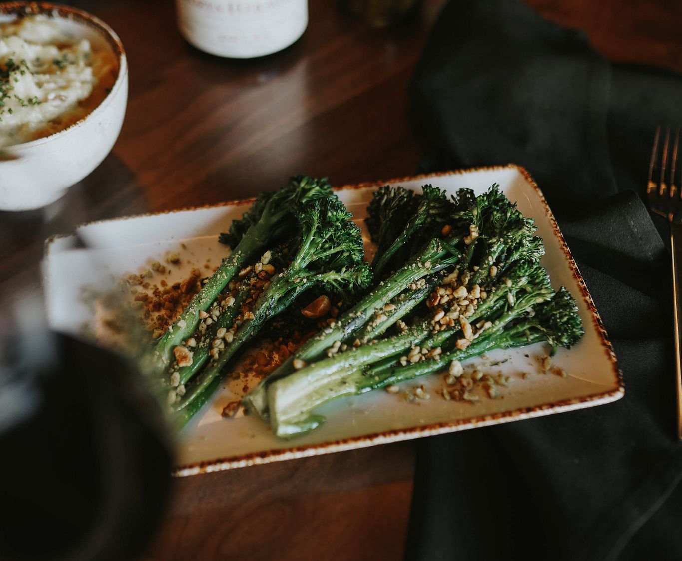 Crusted broccolini on a plate in a restaurant