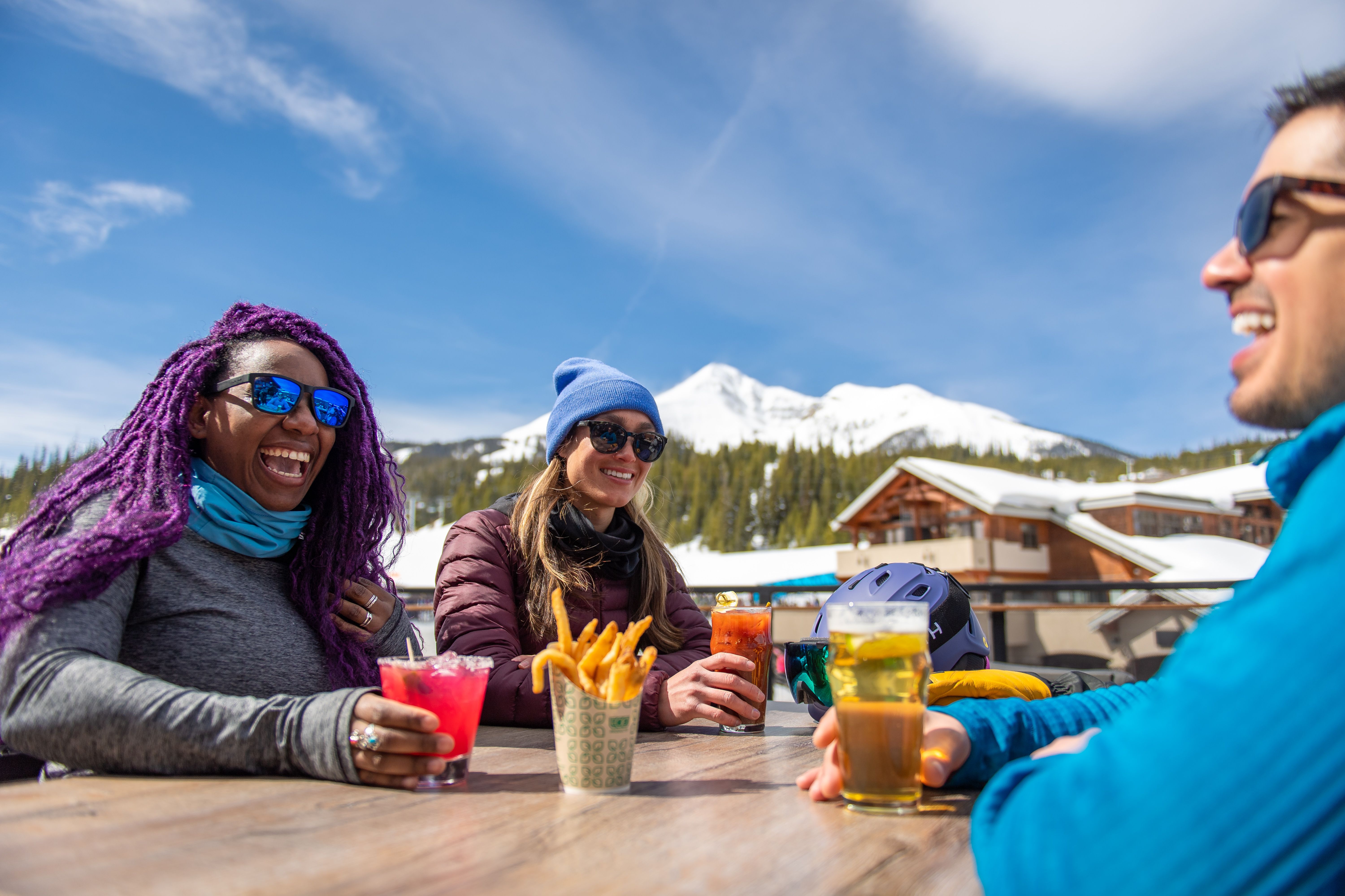 Group of people sitting at the Vista Deck with food and drinks